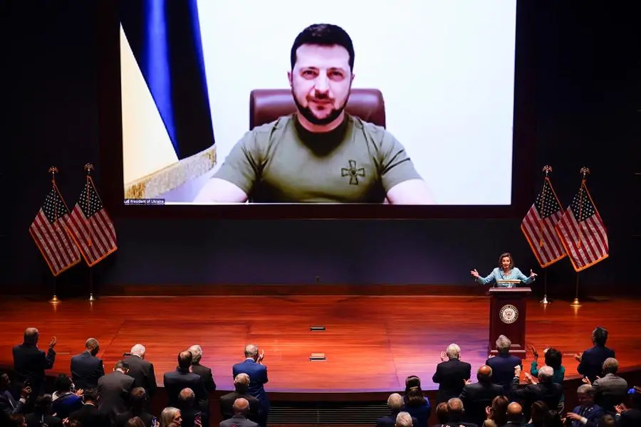 epa09828853 Speaker of the House Nancy Pelosi (R) introduces Ukrainian President Volodymyr Zelensky (on screen) to speak to the US Congress by video to plead for support as his country is besieged by Russian forces, at the Capitol in Washington, USA, 16 March 2022. EPA/SCOTT APPLEWHITE / POOL