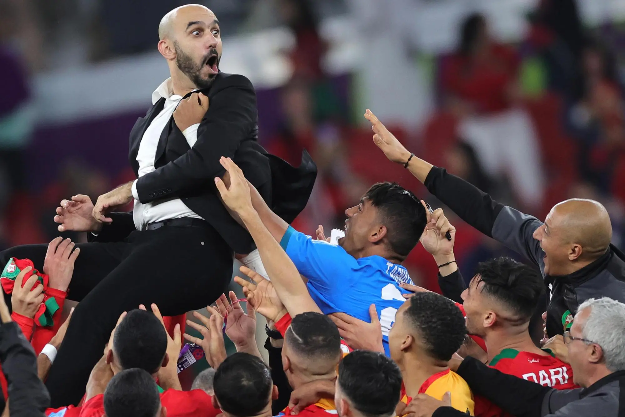 epaselect epa10359682 Head coach of Morocco, Walid Regragui (up) celebrates winning the FIFA World Cup 2022 quarter final soccer match between Morocco and Portugal at Al Thumama Stadium in Doha, Qatar, 10 December 2022. EPA/Abir Sultan