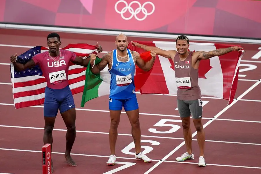Marcell Jacobs (al centro): per la prima volta l'inno italiano è risuonato sul podio dei 100 metri piani (Epa)