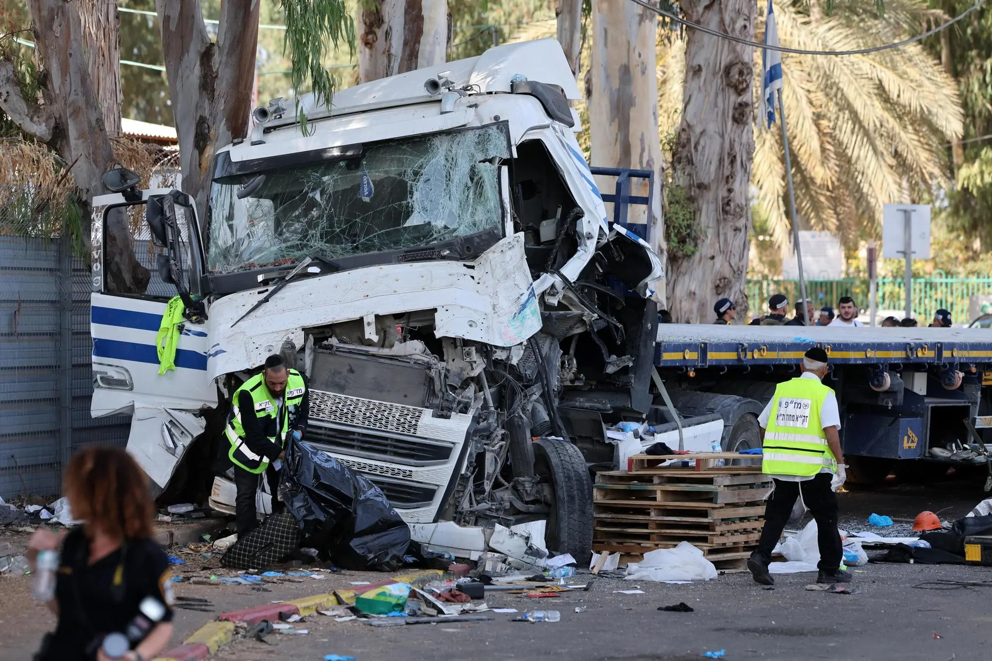 epa11686482 Israeli emergency personnel work at the scene of a truck ramming outside Glilot military base near Tel Aviv, Israel, 27 October 2024. According to the police spokesperson's unit, a truck rammed into and collided with a bus stopping to drop off passengers at the Gilot base station. Magen Davon Adom, Israel's emergency services, reports at least 24 people were injured in the incident. The circumstances of the incident are currently under investigation. EPA/ABIR SULTAN