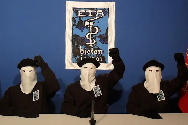 UNSPECIFIED - UNDATED: In this undated image provided by Gara, three Eta militants pose in front of the group's symbol of a snake coiled around an axe, in support of a declaration released on October 20, 2011 stating a "definitive cessation" to it's four decade long campaign of armed conflict in seeking an independent Basque homeland from Spain and France. (Photo released by Gara via Getty Images)