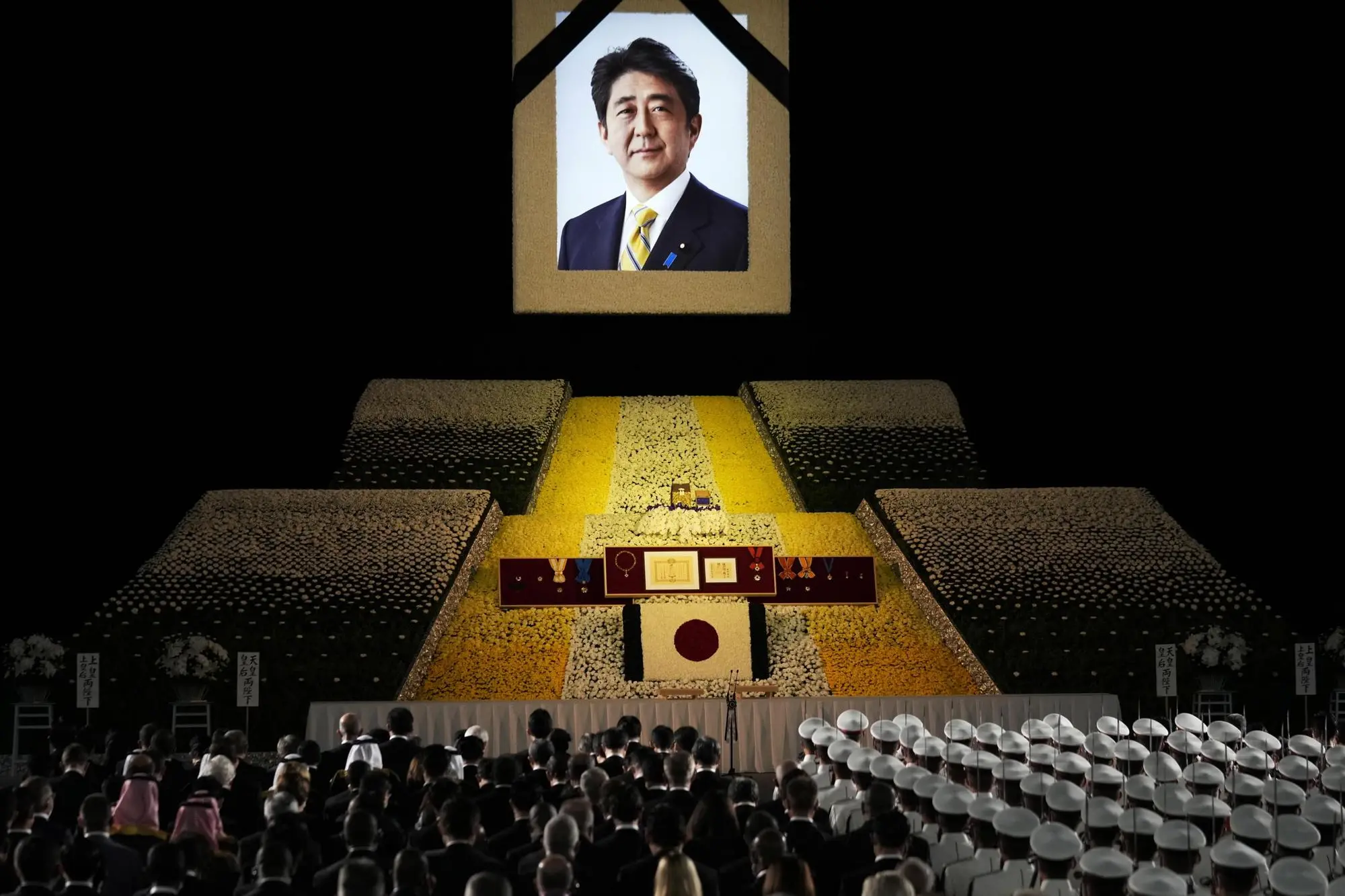 epaselect epa10208695 A portrait of former Japanese Prime Minister Shinzo Abe hangs on the stage during the state funeral of former Japanese Prime Minister Shinzo Abe at Nippon Budokan in Tokyo, Japan, 27 September 2022. Thousands of people are gathered in Tokyo to attend the state funeral for former prime minister Shinzo Abe, including foreign dignitaries and representatives from more than 200 countries and international organizations. EPA/FRANCK ROBICHON / POOL