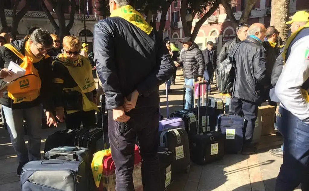 I manifestanti si sono presentati in piazza con una valigia
