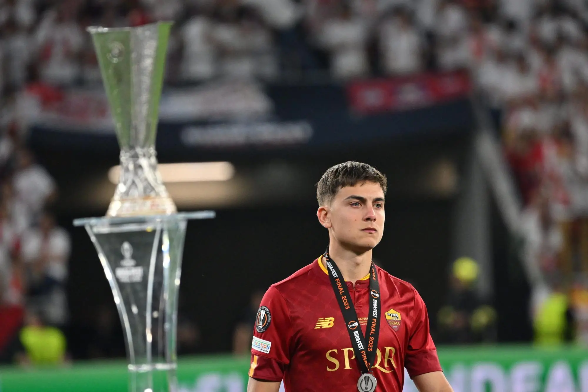 epa10665994 Paulo Dybala of Rome reacts next to the trophy after the UEFA Europa League final between Sevilla FC and AS Roma in Puskas Arena in Budapest, Hungary, 01 June 2023. Sevilla won the final with 4-1 on penalties. EPA/Tibor Illyes HUNGARY OUT