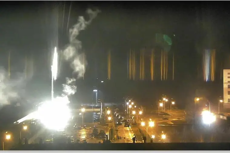 epa09800930 A screen grab taken from a surveillance camera footage the Zaporizhzhya NPP published on YouTube shows a flare landing at the Zaporizhzhia nuclear power plant during shelling, Ukraine, 04 March 2022. A fire at Zaporizhzhia, the largest nuclear power plant in Europe, was was extinguished after shelling by Russia earlier in the day, the State Emergency Service said. Russian troops entered Ukraine on 24 February prompting the country's president to declare martial law and triggering a series of severe economic sanctions imposed by Western countries on Russia. EPA/Zaporizhzhya NPP / HANDOUT HANDOUT EDITORIAL USE ONLY/NO SALES