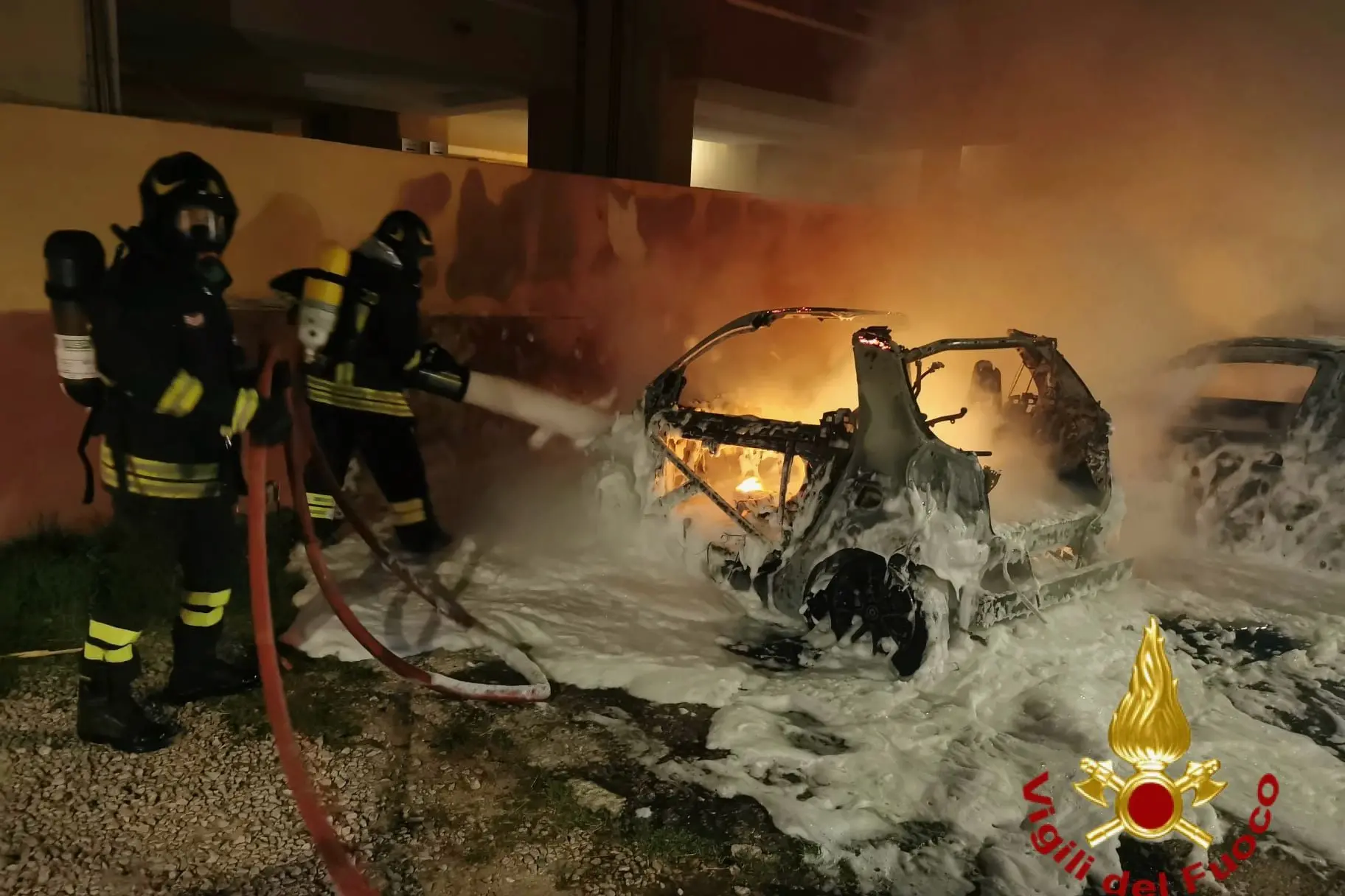 Firefighters in action to put out an arson fire in Olbia