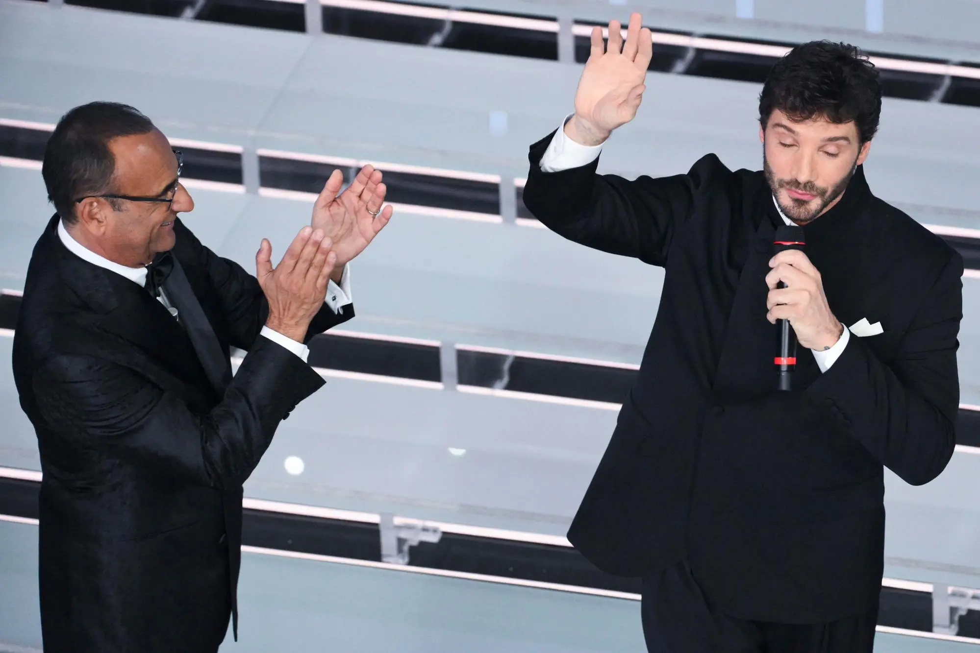 Sanremo Festival host and artistic director Carlo Conti (L) with Italian tv presenter Stefano De Martino (R) on stage at the Ariston theatre during the 76th edition of the Sanremo Italian Song Festival, in Sanremo, Italy, 28 February 2026. The music festival will run from 24 to 28 February 2026. ANSA/ETTORE FERRARI