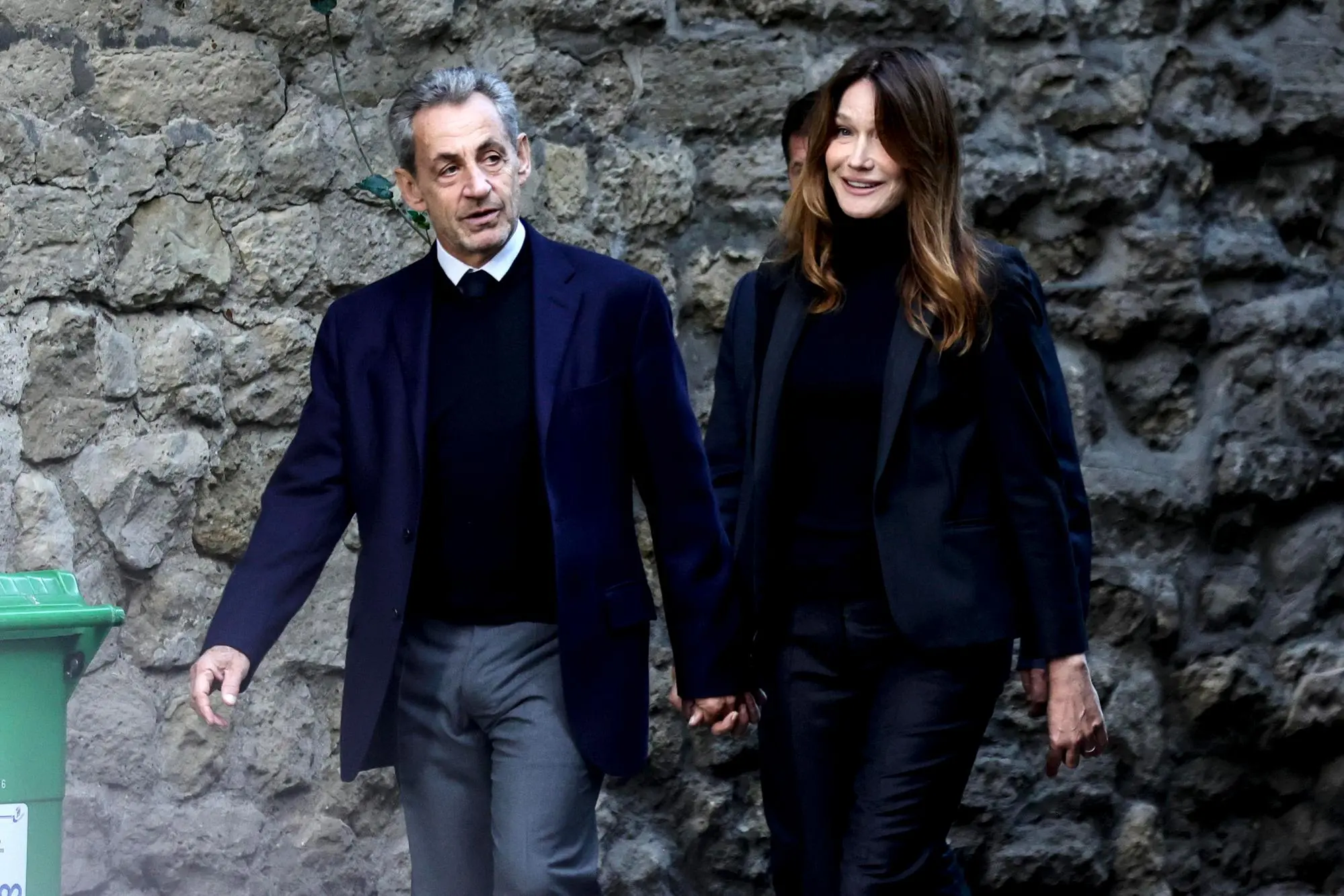 epa12469276 Former French President Nicolas Sarkozy (L) and his wife, Carla Bruni (R), leave the family home the day the former is due to enter prison in Paris, France, 21 October 2025. Nicolas Sarkozy will serve his five-year sentence at La Sante prison on 21 October after he was sentenced to five years in prison for receiving funds for the 2007 presidential campaign from the regime of late Libyan leader Muammar Gaddafi. EPA/TERESA SUAREZ