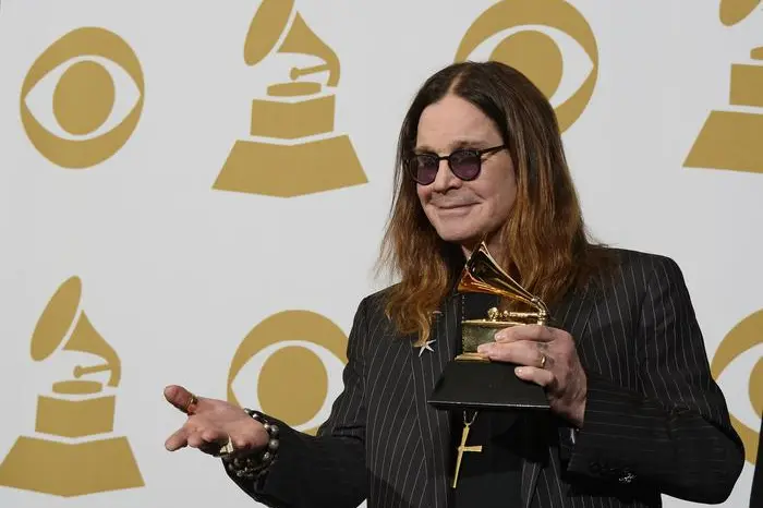 epa04043821 British singer Ozzy Osbourne of Black Sabbath holds up the award for 'Best Metal Performance' at the 56th annual Grammy Awards held at the Staples Center in Los Angeles, California, USA, 26 January 2014. EPA/PAUL BUCK