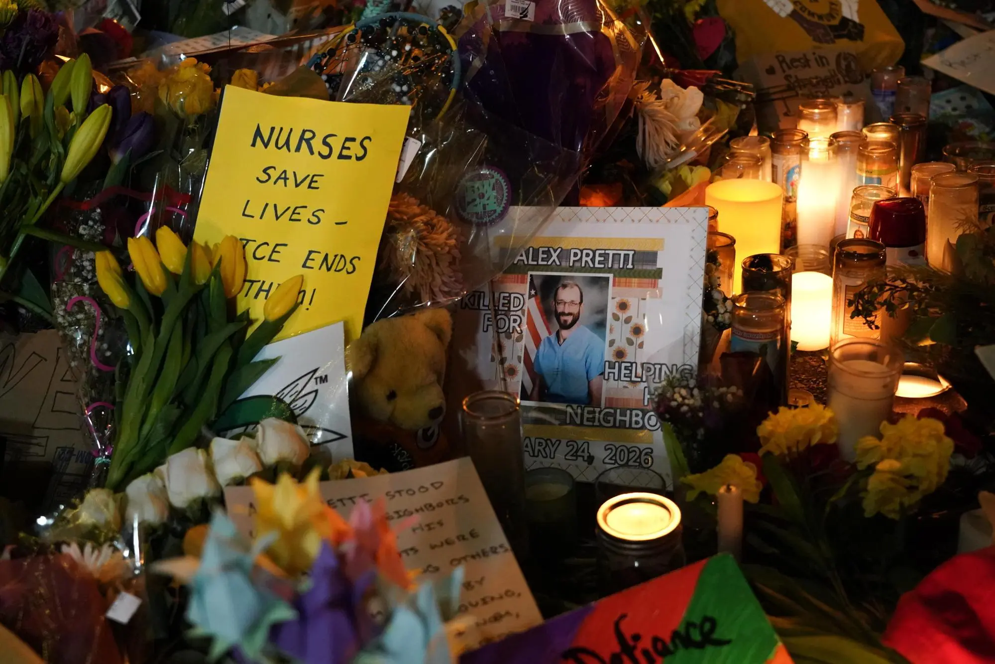 epa12683789 Flowers, candles and messages are left at the memorial where Alex Pretti was fatally shot by federal agents in south Minneapolis, Minnesota, USA, 26 January 2026. Pretti is the second person killed by federal officers in Minneapolis this month. EPA/CRAIG LASSIG