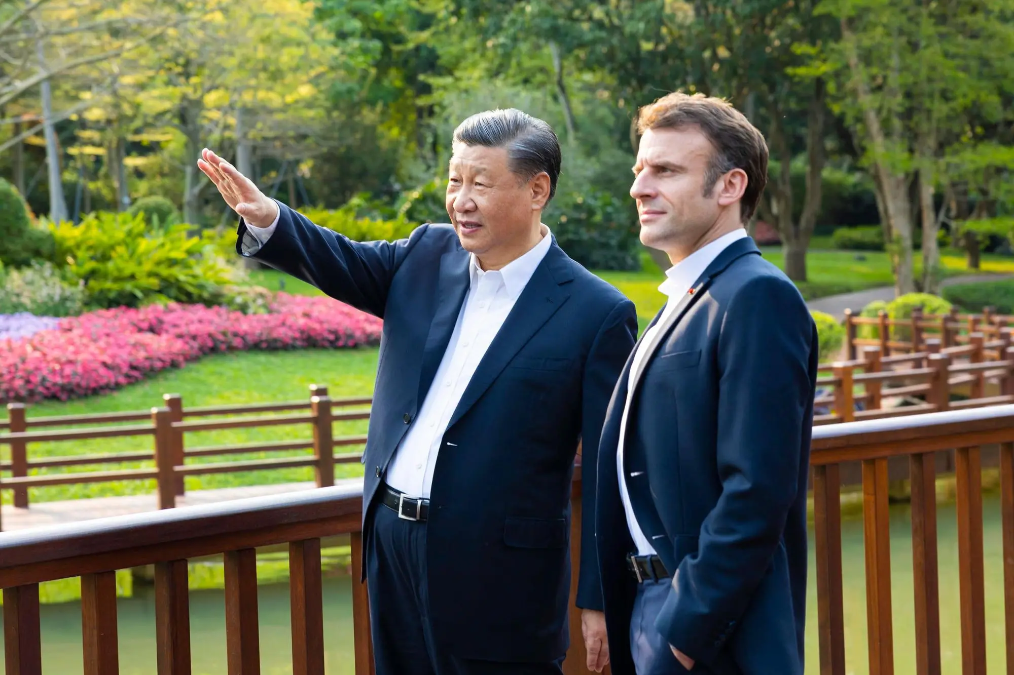 epa10564460 Chinese President Xi Jinping (L) and French President Emmanuel Macron (R) chat during a stroll through the Pine Garden in Guangzhou, Guangdong Province, China, 07 April 2023 (issued 08 April 2023). EPA/XINHUA / Huang Jingwen CHINA OUT / MANDATORY CREDIT EDITORIAL USE ONLY