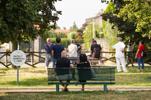 Passanti davanti alla casa della strage a Paderno (Spf- Ansa)