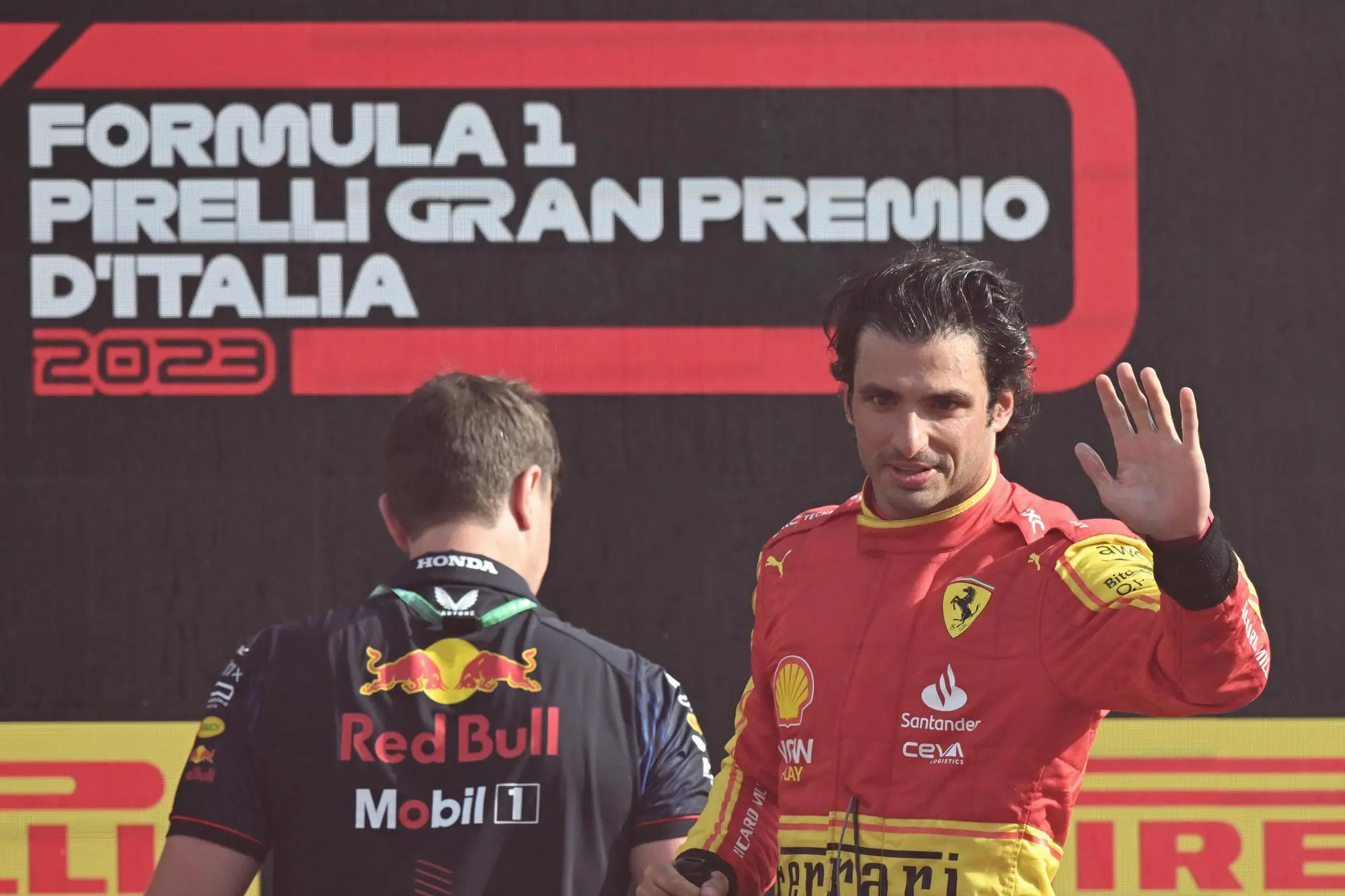 Third placed Spanish driver Carlos Sainz of Scuderia Ferrariwaves the supporters from the podium of the Italian Formula One Grand Prix at the Autodromo Nazionale in Monza, Italy, 3 september 2023. ANSA/DANIEL DAL ZENNARO