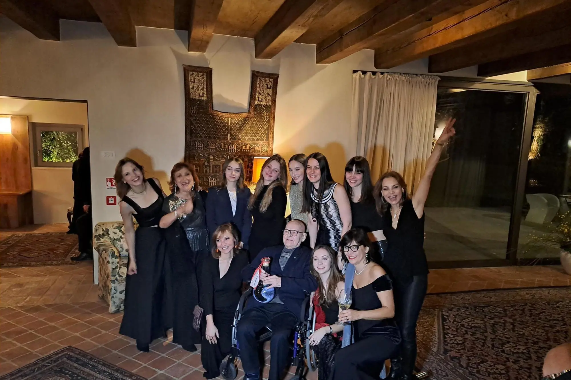 Benito Nonino al centro con una bottiglia di grappa, insieme con la moglie, le figlie, le nipoti, in occasione del Premio Nonino 2024 (Ansa)