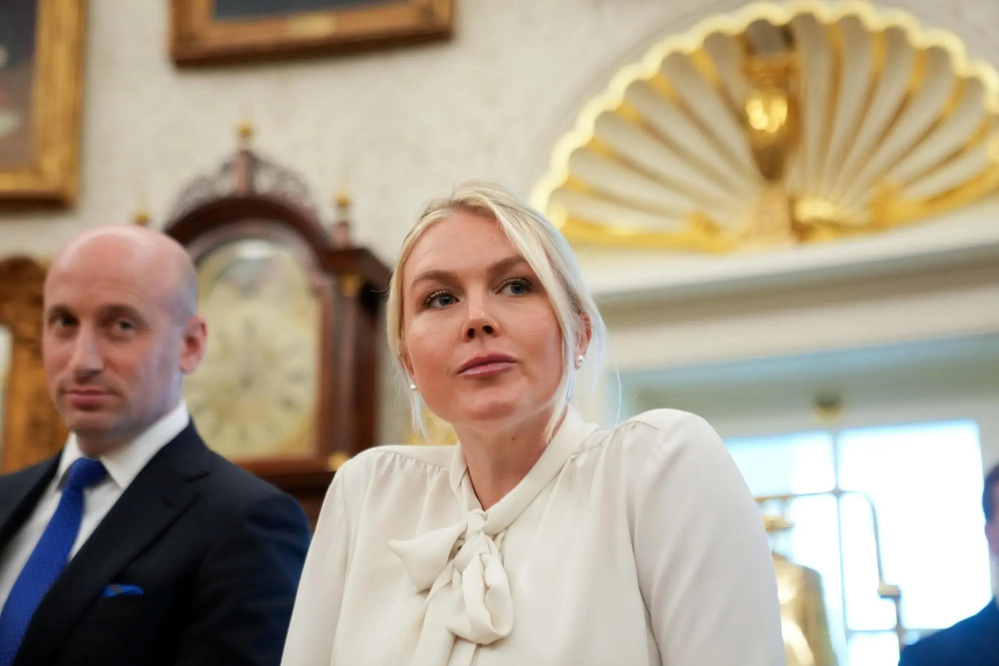epa13148890 White House press secretary Karoline Leavitt and Deputy Chief of Staff Stephen Miller (L) look on as US President Donald Trump announces an executive order establishing the Presidential Military Spouse Commission, in the Oval Office at the White House in Washington, DC, USA, 03 August 2026. EPA/Allison Robbert / POOL