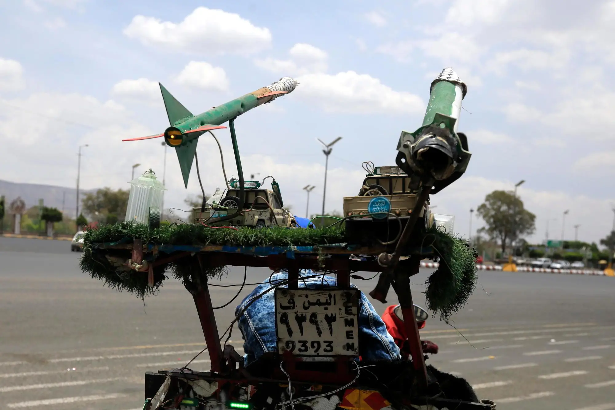 epa12075491 A person rides a motorcycle decorated with mock missiles along a street in Sana'a, Yemen, 05 May 2025. Yemen's Houthis have announced they will impose a 'comprehensive air blockade' on Israel, warning international airlines that Israel's airports are no longer safe for air traffic, a day after they claimed responsibility for a missile strike that targeted Israel's Ben Gurion airport, according to a statement by Houthi military spokesman Yahya Sarea. EPA/YAHYA ARHAB