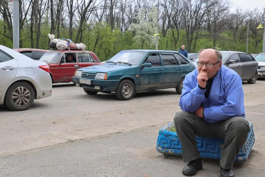 epa09916985 Local people wait on a road as they are evacuating from Ruska Lozova village near Kharkiv, Ukraine, 29 April 2022. People try to leave the conflict area as Ruska Lozova has recently been recaptured by the Ukrainian army from Russian forces in heavy fighting. Russian troops entered Ukraine on 24 February resulting in fighting and destruction in the country and triggering a series of severe economic sanctions on Russia by Western countries. EPA/SERGEY KOZLOV