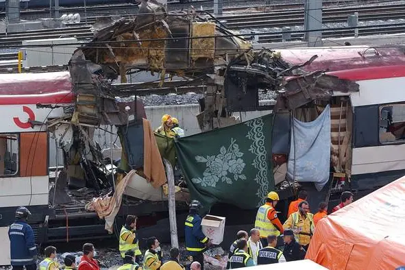 epa00151573 Rescue workers, police and medical services work alongside a bomb damaged passenger train at the Atocha station in Madrid, Spain, Thursday 11 March 2004, following a number of explosions that killed more than 170 rush-hour commuters and wounding more than 500 in Spain's worst terrorist attack ever just three days before Spain's general elections. EPA/BERNARDO RODRIGUEZ