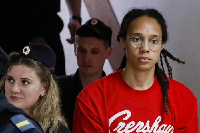epa10056851 Two-time Olympic gold medalist and WNBA's Phoenix Mercury Brittney Griner (R) is escorted to a courtroom for a hearing, in Khimki City Court, outside Moscow, Russia, 07 July 2022. The Khimki City Court reportedly had extended Griner's detention for the duration of her trial on charges of drug smuggling that started on 01 July. Griner was arrested in February at Moscow's Sheremetyevo Airport after some hash oil was detected and found in her luggage, for which she now could face a prison sentence of up to ten years. EPA/YURI KOCHETKOV