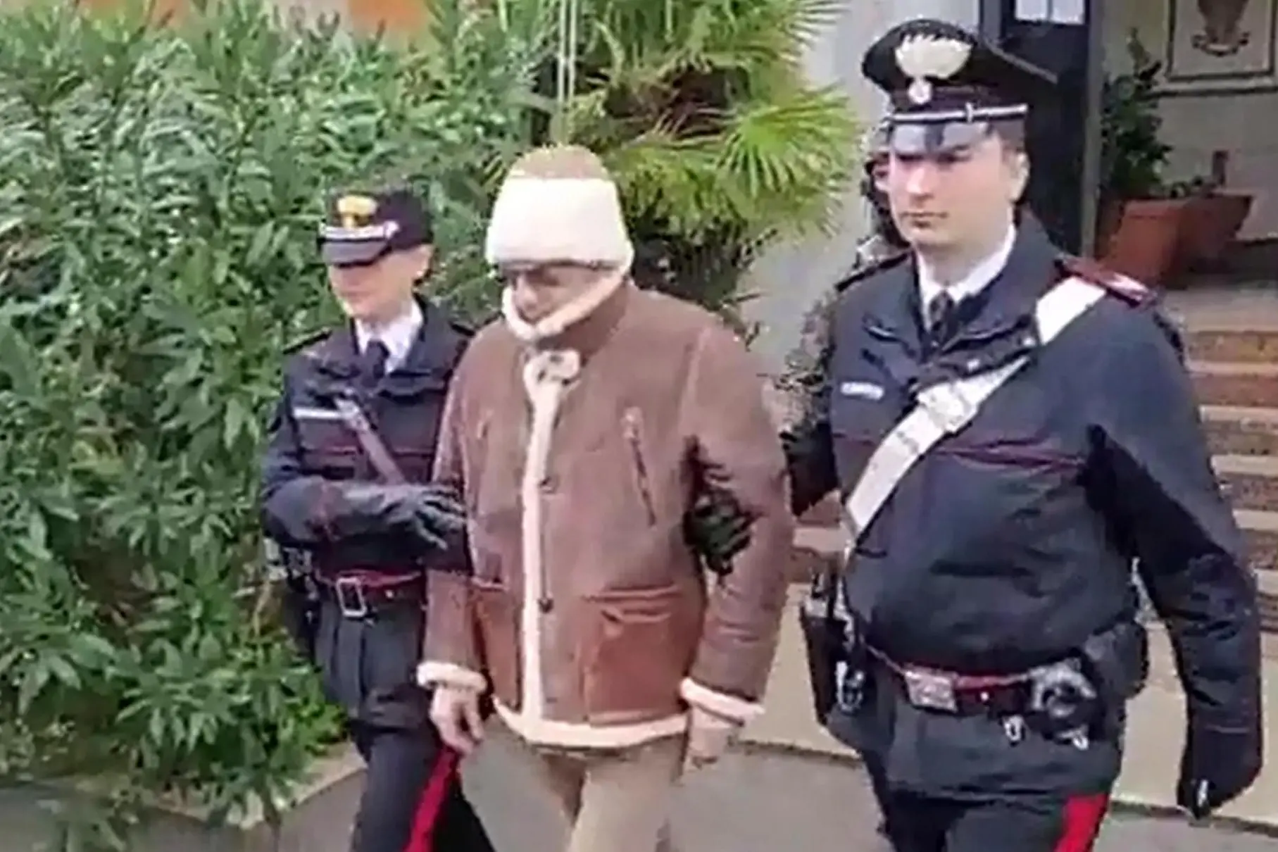 A handout photo made available by Italy's Carabinieri shows a video frame of the Mafia boss Matteo Messina Denaro (C), Italy's most wanted man, being arrested in Palermo, Sicily, by the Carabinieri police's ROS unit after 30 years on the run in Palermo, Sicily island, Italy, 16 January 2023. ANSA/US CARABINIERI +++ NO SALES, EDITORIAL USE ONLY +++ NPK +++