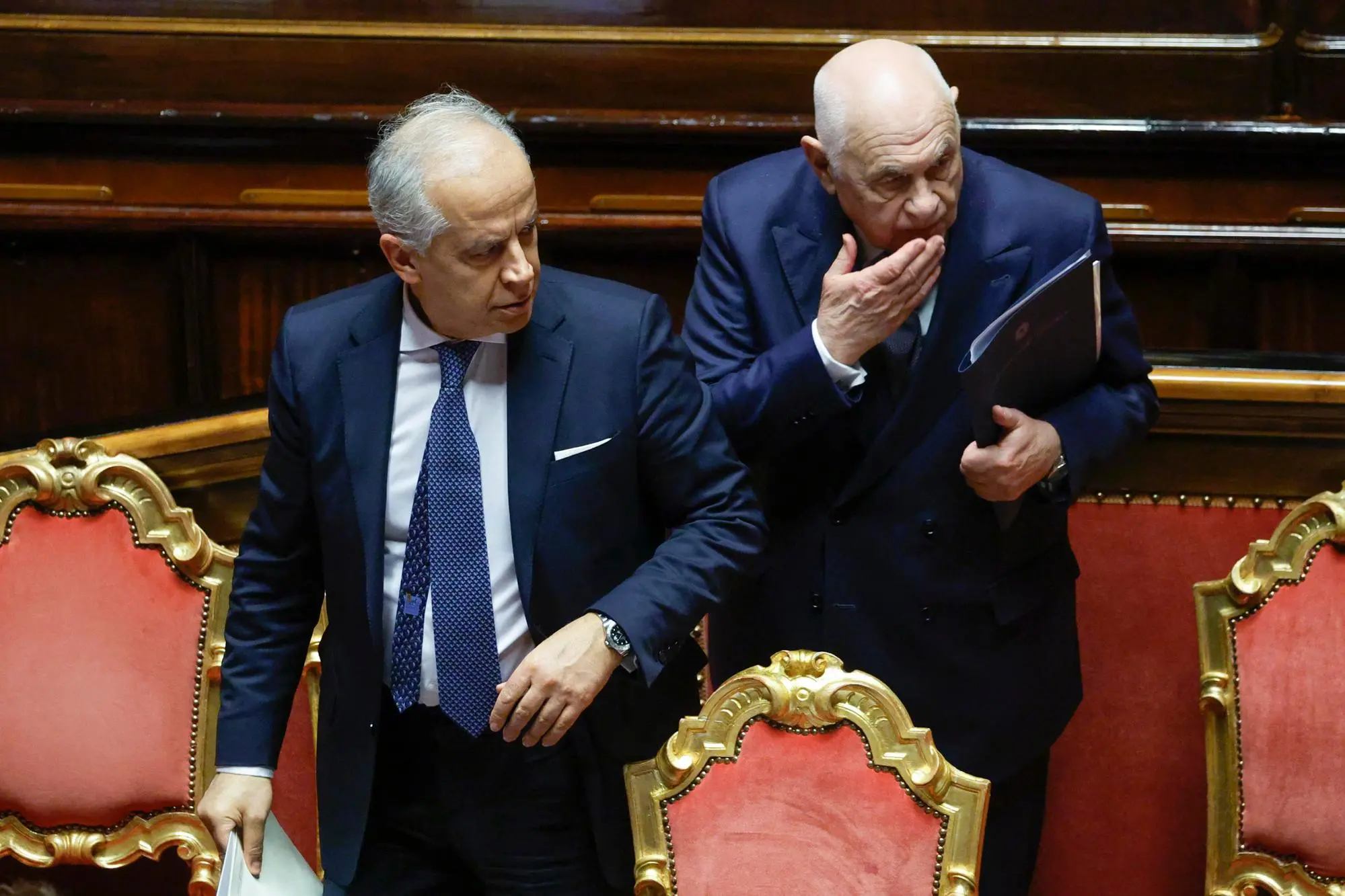 Italy's Justice Minister Carlo Nordio (R) and Interior Minister Matteo Piantedosi react during a government briefing over the case of Libyan General Osama Najim Almasri, at the Senate, Rome, Italy, 05 February 2025. On 21 January the Italian government released and repatriated Almasri after a brief detention over an International Criminal Court (ICC) arrest warrant. The general is wanted by the ICC over allegations of war crimes and crimes against humanity. ANSA/FABIO FRUSTACI