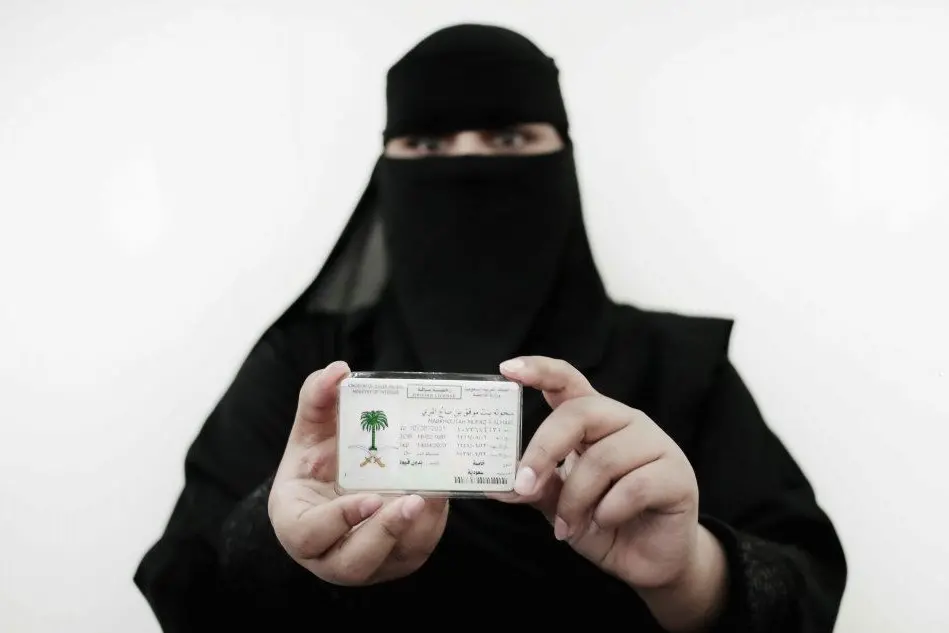 Una donna mostra la sua patente di guida