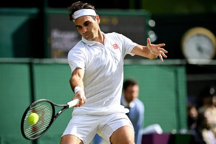 epa09329204 Roger Federer of Switzerland hits a forehand during the men's quarter final match against Hubert Hurkacz of Poland at the Wimbledon Championships, in Wimbledon, Britain, 07 July 2021. EPA/NEIL HALL EDITORIAL USE ONLY