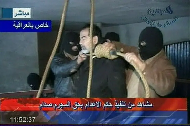 This video image released by Iraqi state television shows Saddam Hussein's guards wearing ski masks and placing a noose around the deposed leader's neck moments before his execution Saturday Dec. 30. 2006. Clutching a Quran and refusing a hood, Saddam Hussein went to the gallows before sunrise Saturday, executed by vengeful countrymen after a quarter-century of remorseless brutality that killed countless thousands and led Iraq into disastrous wars against the United States and Iran. (AP Photo/IRAQI TV, HO)