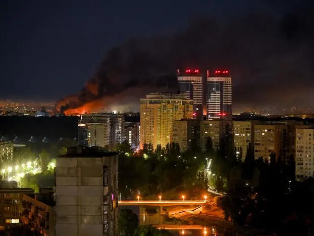 This photograph shows smoke billowing from a fire during drone and missile attacks in Kyiv on June 2, 2026, amid the Russian invasion in Ukraine. Russian missile and drone barrages rocked parts of Ukraine overnight, killing four and wounding dozens, officials said on June 2, the latest attacks in a war with no end in sight. (Photo by Evgen KOTENKO / AFP)