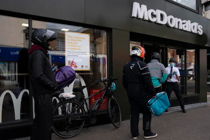 epa08419934 A general view showing delivery drivers outside of a McDonald's outlet in Tooting, Central London, Britain, 13 May 2020. McDonalds has reopened some branches for delivery only, after British Prime Minister Boris Johnson set out a plan to reopen Britain on 10 May. People who can't work from home are now actively encouraged to return to workplaces, but use of public transport is being discouraged. EPA/WILL OLIVER
