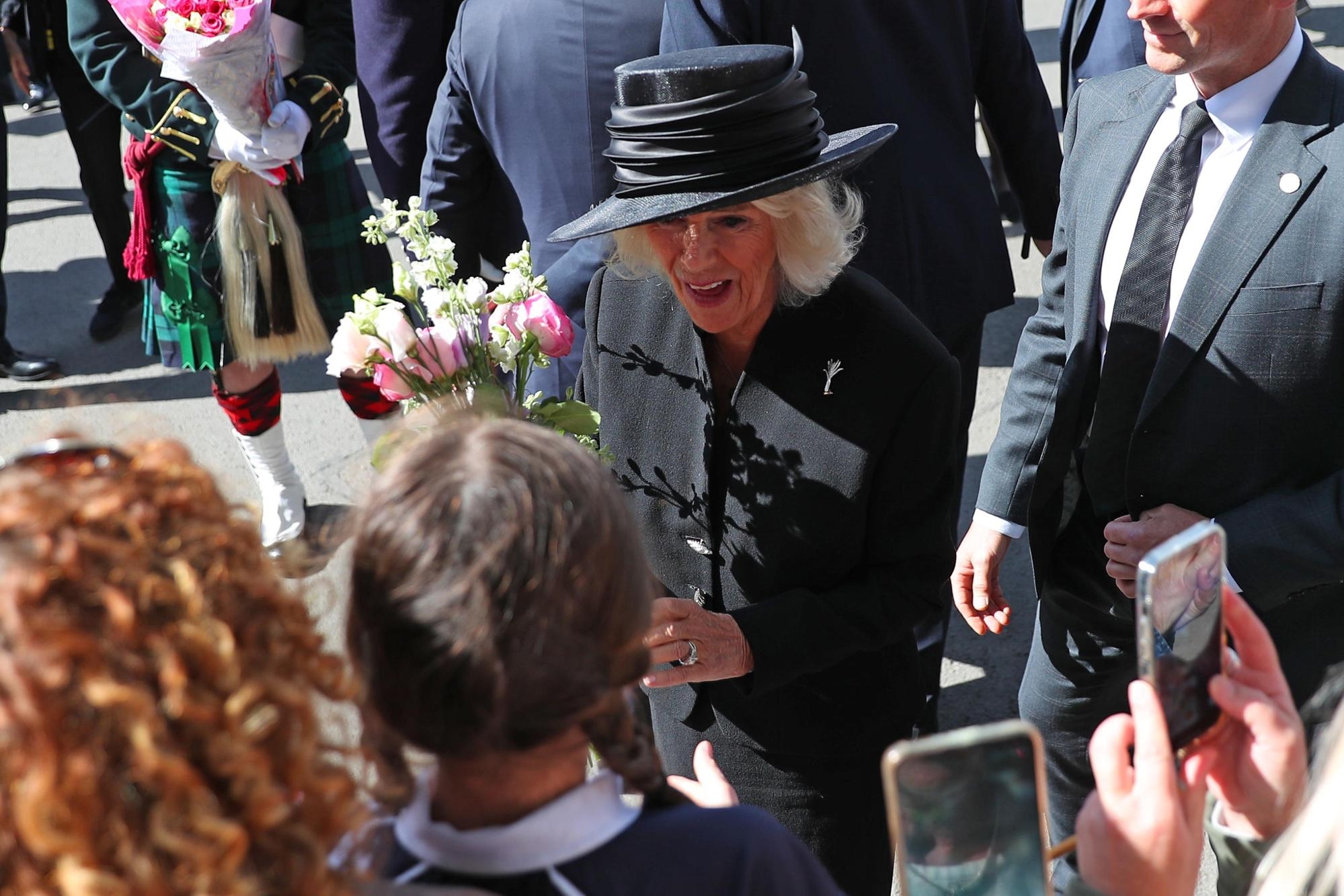 epa10188196 Britain's Queen Consort Camilla greets people as she leaves a memorial service for late Queen Elizabeth II at Llandaff Cathedral in Cardiff, Wales, Britain, 16 September 2022. King Charles visited Wales, ending his first round of visits to the nations of the United Kingdom since he was proclaimed monarch on 10 September. Charles III received condolences from the parliament, government and other authorities of Wales and attended a religious ceremony at Llandaff Cathedral in memory of his mother, Queen Elizabeth II, who died on September 08. EPA/NUNO VEIGA