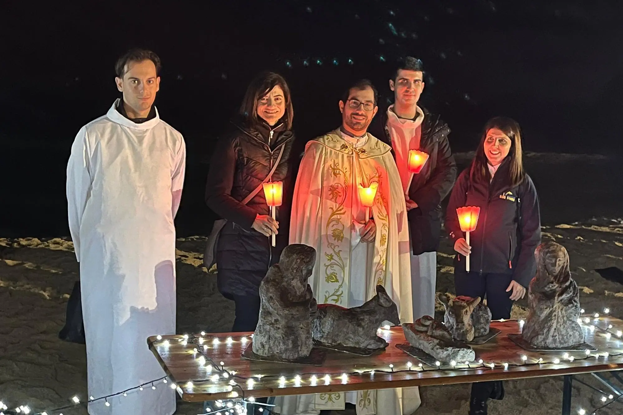 Il parroco di Solanas con le statuette del presepe prima di essere state sistemate nei fondali di Solanas