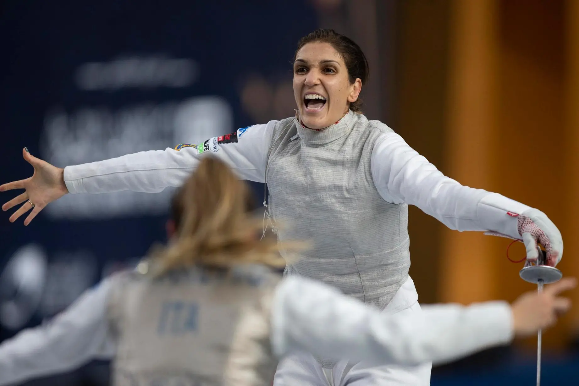 epa10086614 Arianna Errigo of Italy celebrates after winning against the USA in the Senior Team Women's Foil gold medal match at the Fencing World Championships in Cairo, Egypt, 22 July 2022. EPA/MOHAMED HOSSAM