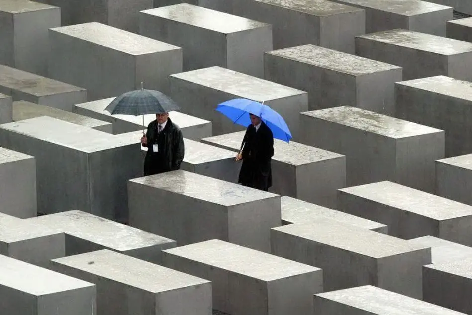 Due visitatori al Memoriale dell'Olocausto a Berlino (Ansa)