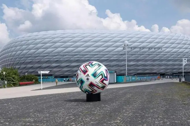 Il pallone degli Europei sullo sfondo di uno degli 11 stadi (foto Ansa)