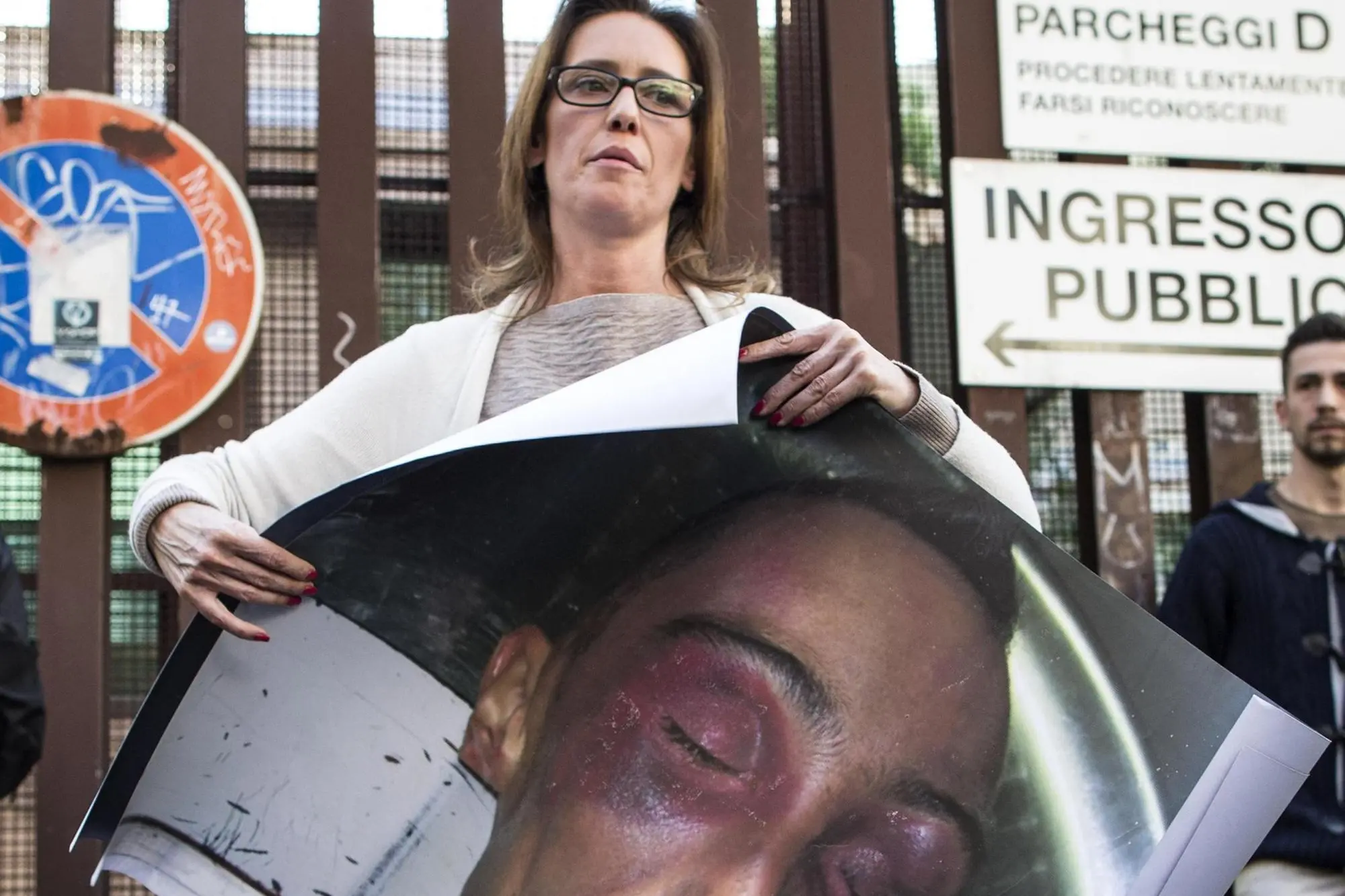 Ilaria Cucchi con la foto del fratello Stefano dopo il pestaggio (Ansa)