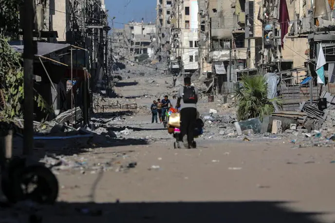 epa12438379 Palestinians move on the damaged Al-Nassr street during an Israeli military operation in Gaza City, Gaza Strip, 07 October 2025. According to the UN around 90 percent of the population or 1.9 million people in Gaza have been displaced since the start of the conflict. More than 67,000 Palestinians have been killed in the Gaza Strip since October 2023, according to the Palestinian Ministry of Health, and about 1,200 Israelis have been killed since the launch of an Israeli military campaign in response to a cross-border attack by Hamas on 07 October 2023. EPA/MOHAMMED SABER