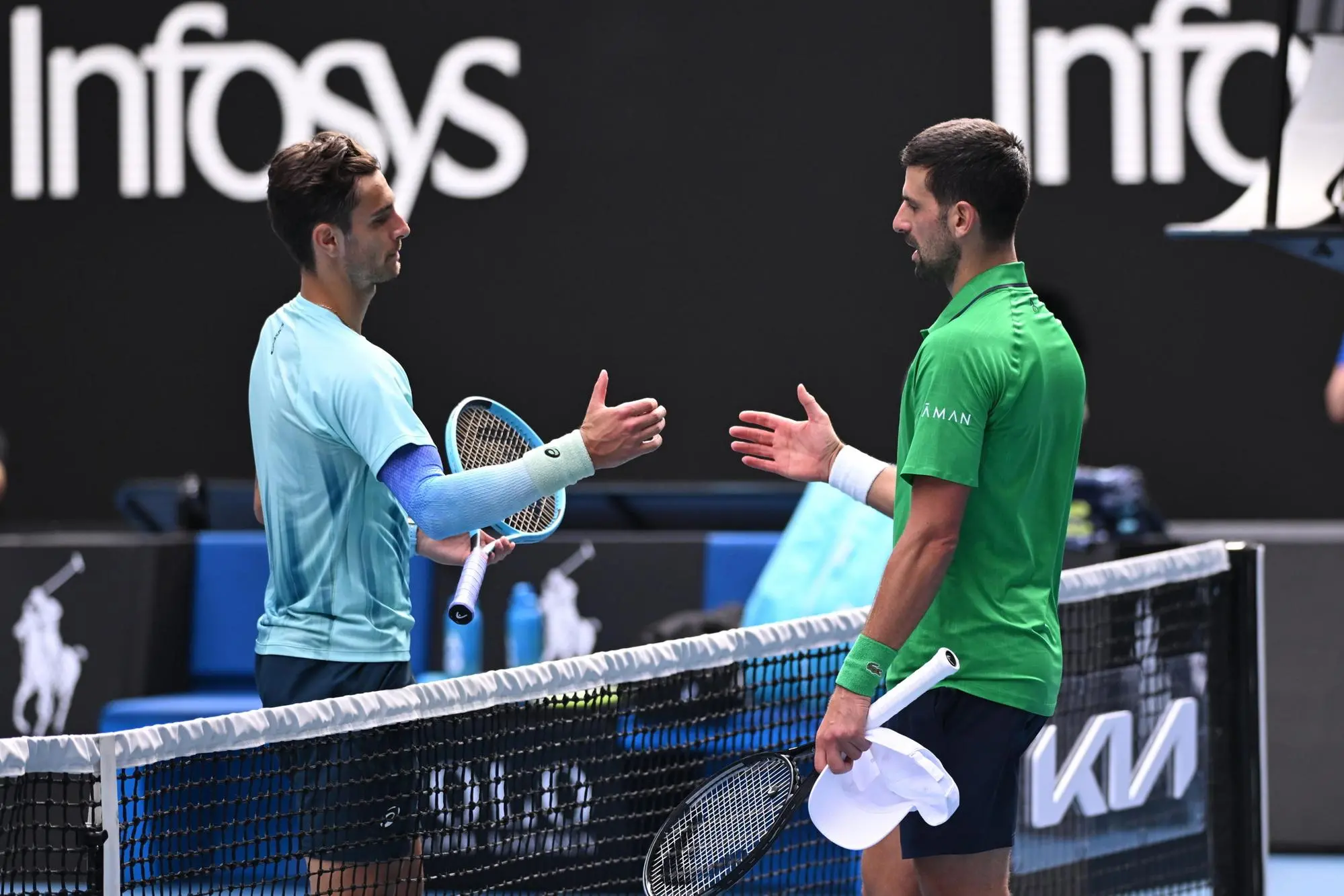 Lorenzo Musetti (L) of Italy retires injured during his men’s quarterfinals against Novak Djokovic of Serbia (Ansa)