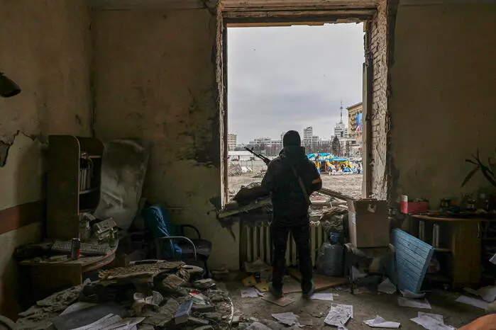 epaselect epa09794048 A member of the Territorial Defense Forces of Ukraine stands inside the damaged Kharkiv regional administration building in the aftermath of a shelling in downtown Kharkiv, Ukraine, 01 March 2022. Russian troops entered Ukraine on 24 February prompting the country's president to declare martial law and triggering a series of announcements by Western countries to impose severe economic sanctions on Russia. EPA/SERGEY KOZLOV