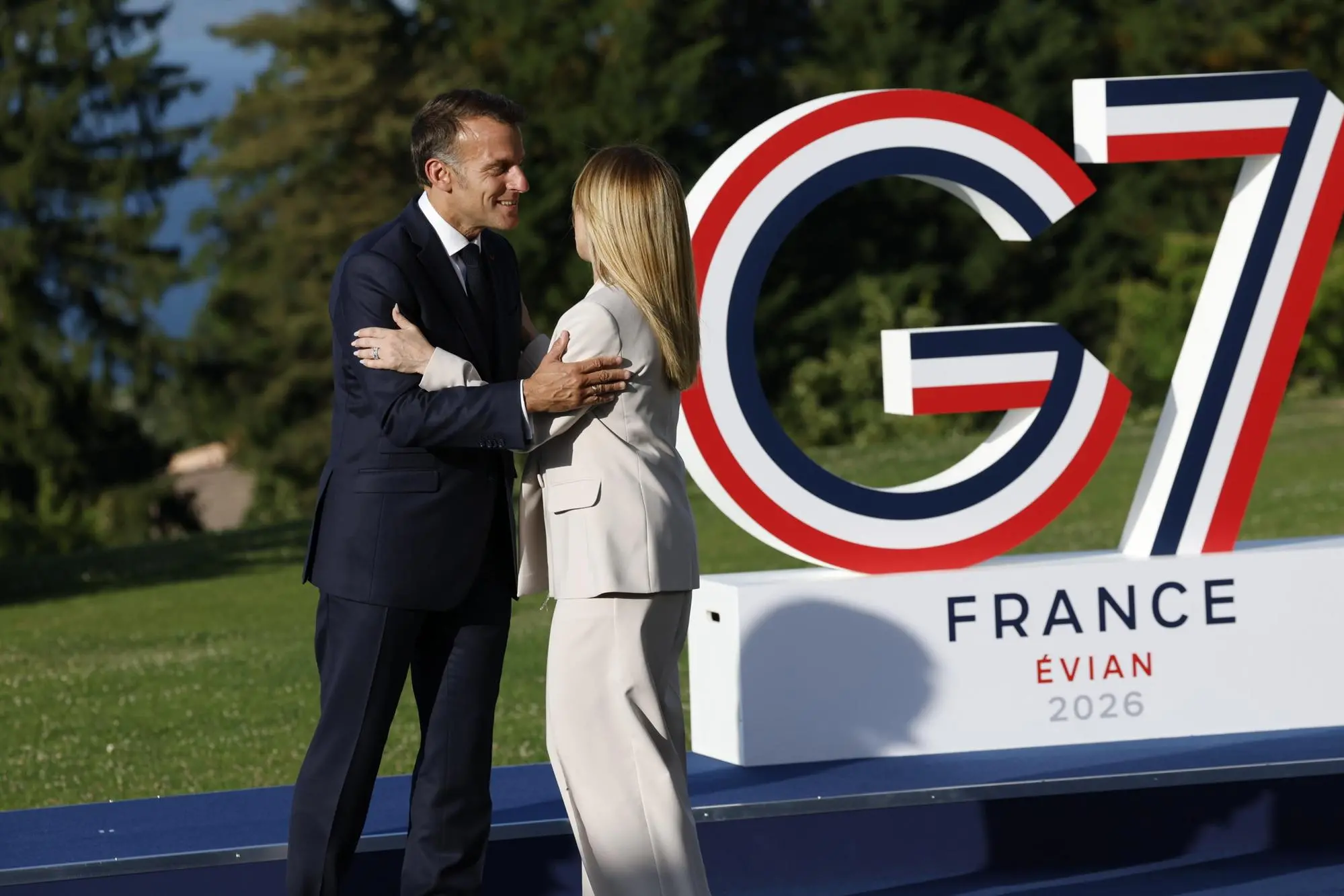epa13039646 French President Emmanuel Macron (L) welcomes Italy's Prime Minister Giorgia Meloni (R) at the Hotel Royal ahead of the G7 summit in Evian-les-Bains, France, 15 June 2026. The 52nd G7 Summit takes place in Evian-les-Bains from 15 to 17 June 2026. EPA/YOAN VALAT