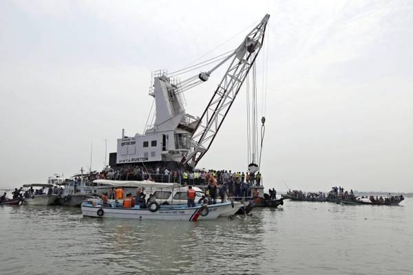 epa03143064 The recovery ship Rustom over the sunken ship following a ferry accident in Meghna at Gozaria, Munshigonj, Bangladesh 13 March 2012. Reports state that at least 31 people were killed and around 200 were still missing after a ferry capsized and sank. The MV Shariatpur-1 capsized and sank in the Meghna River near Charjhapta, 60 kilometers south of Dhaka, after it collided with a cargo vessel an officer of the Munshiganj district police said. EPA/ABIR ABDULLAH
