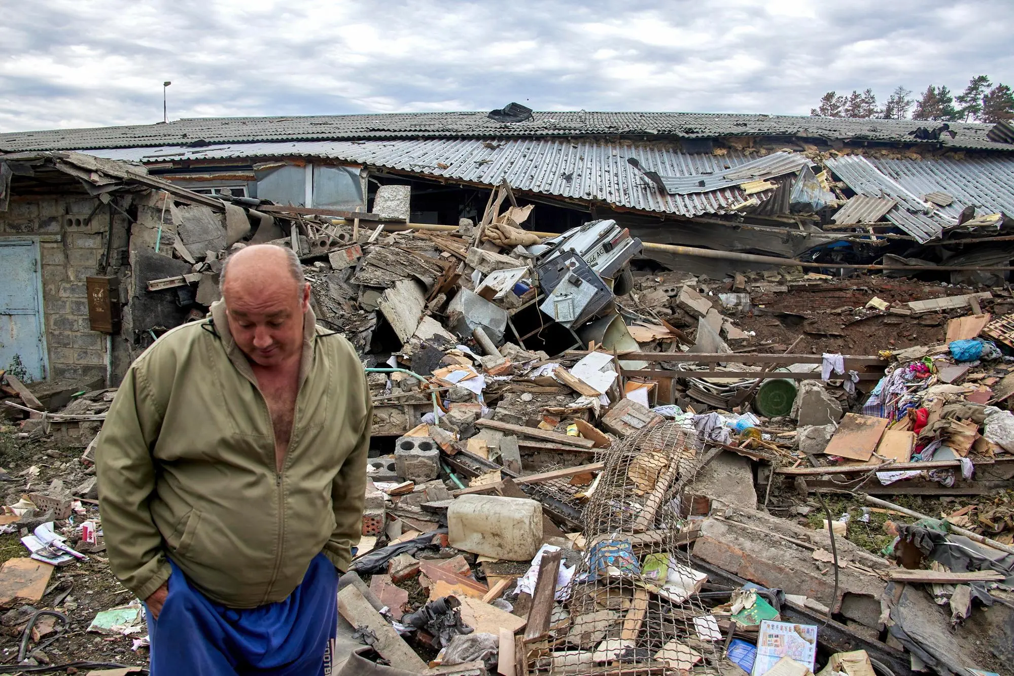 epa10102842 A local man inspects a private building damaged in a rocket hit near Chuhuiv, Kharkiv area, Ukraine, 02 August 2022. Kharkiv and surrounding areas have been the target of heavy shelling since February 2022, when Russian troops entered Ukraine starting a conflict that has provoked destruction and a humanitarian crisis. EPA/SERGEY KOZLOV