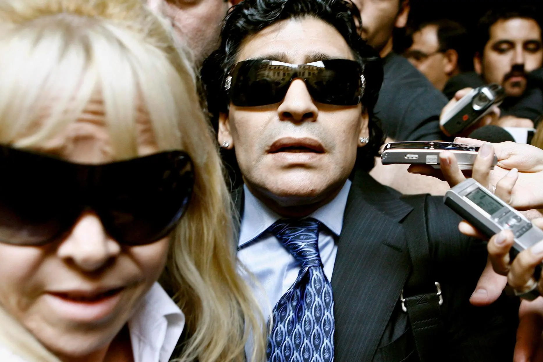 epa08841732 (FILE) - Argentinean soccer legend Diego Maradona (C) and his ex-wife Claudia Villafane (L) leave a court building in Buenos Aires, Argentina, 23 April 2008, where he attended a conciliation audience with former manager Guillermo Coppola (re-issued on 25 November 2020). Diego Maradona has died after a heart attack, media reports claimed on 25 November 2020. The Argentine soccer great was among the best players ever and who led his country to the 1986 World Cup title before later struggling with cocaine use and obesity. He was 60. EPA/LEO LA VALLE