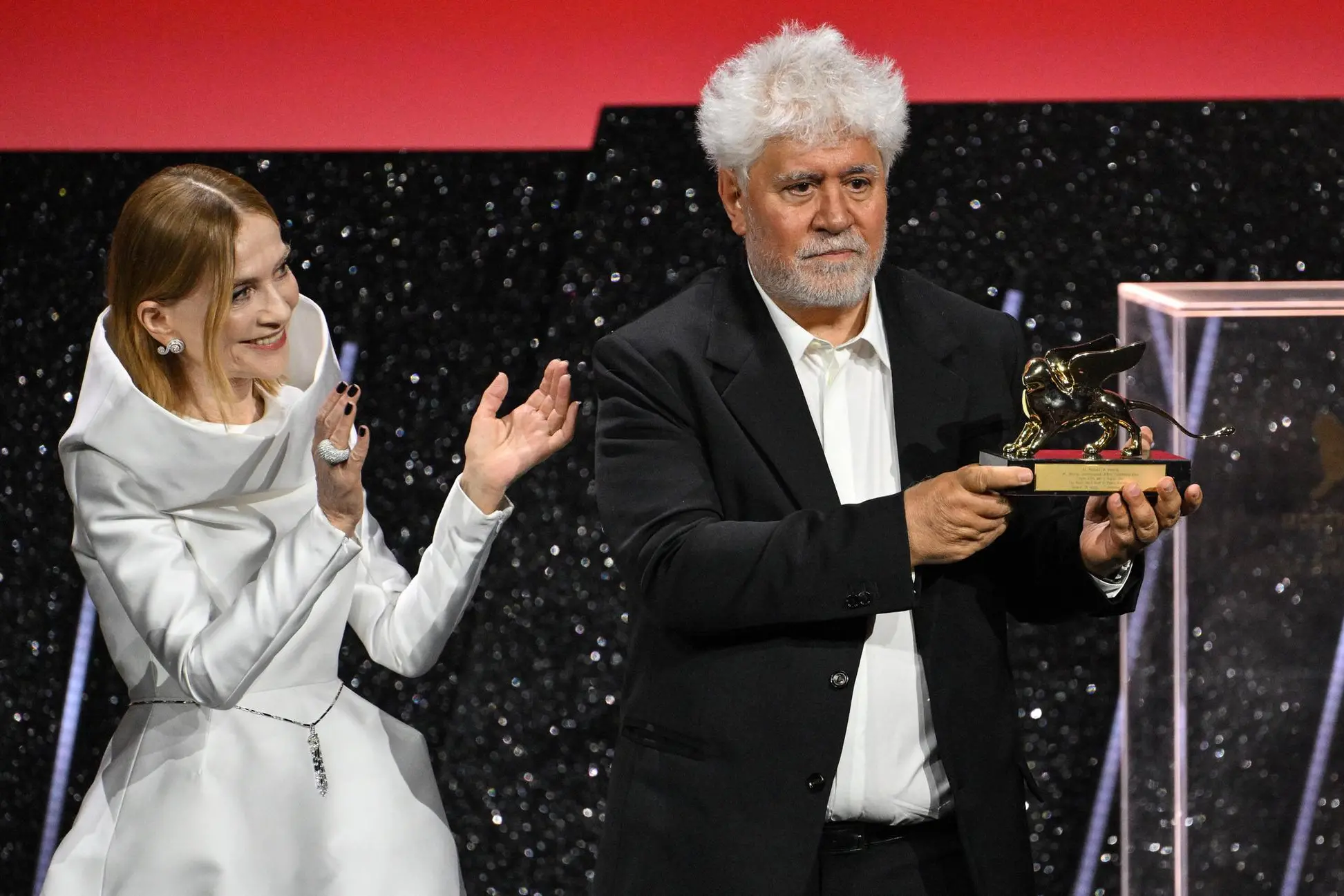 Gli applausi della presidente della giuria della Mostra del cinema di Venezia alla consegna del Leone d'Oro a Pedro Almodovar per il film "The room next door" (Foto Ansa/Ettore Ferrari)