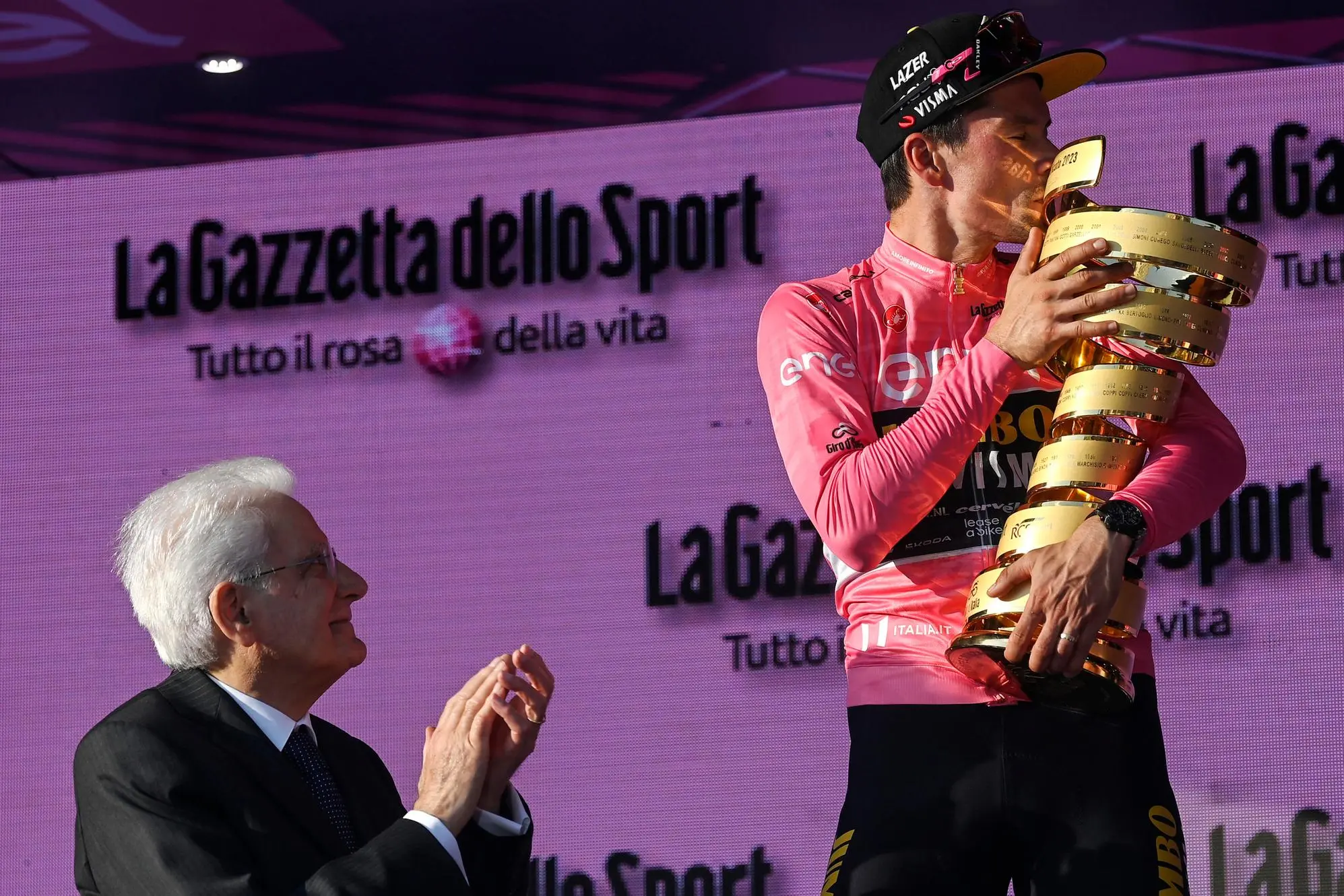 Slovenian rider and winner Primoz Roglic (R), kisses the trophy next to the Italian President of the Republic, Sergio Mattarella (L), after winning the 2023 Giro d'Italia cycling race, Rome, Italy, 28 May 2023. ANSA/RICCARDO ANTIMIANI