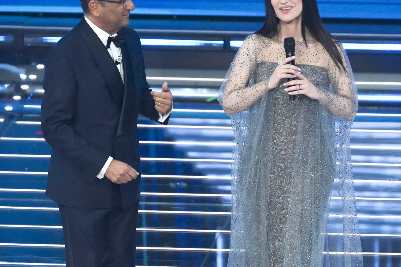 Sanremo Festival host and artistic director Carlo Conti (L) with Italian singer Laura Pausini (R) on stage at the Ariston theatre during the 76th edition of the Sanremo Italian Song Festival, in Sanremo, Italy, 24 February 2026. The music festival will run from 24 to 28 February 2026. ANSA/ETTORE FERRARI