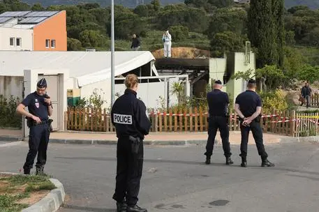 Police officers stand outside a Muslim prayer room set on fire early in the morning in Ajaccio, French Mediterranean island of Corsica, Saturday, April 30, 2016. (ANSA/AP Photo/Jean-Pierre Belzit)