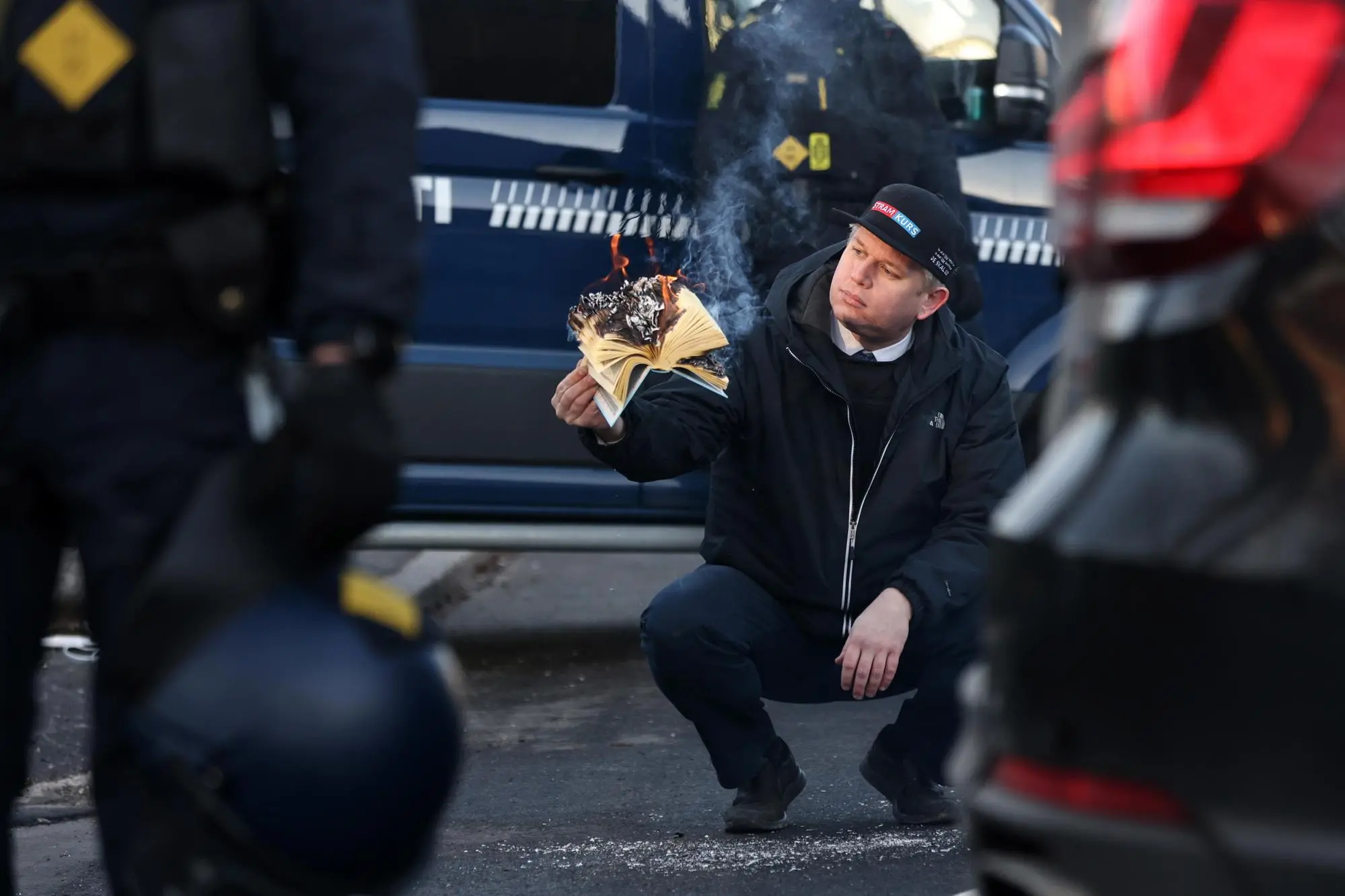 epa10433883 Rasmus Paludan, leader of Danish far-right anti-Islam party Stram Kurs (Hard Line), burns a copy of the Koran in front of the Turkish embassy in Copenhagen, Denmark, 27 January 2023. The action was met with outrage and protests around the world since Paludan burned a copy of the Muslim holy book in Stockholm a week earlier. EPA/Olafur Steinar Gestsson DENMARK OUT