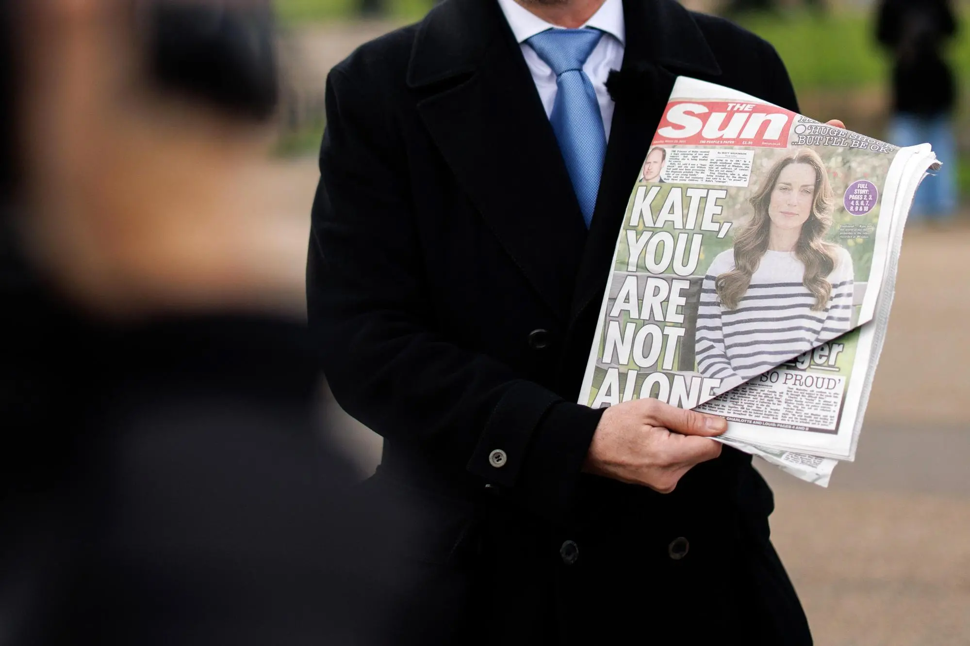epa11238616 A TV reporter shows front the page of a British newspaper during a piece to camera outside Kensington Palace, the residence of Britain's Catherine Princess of Wales, in London, Britain, 23 March 2024. Catherine, the Princess of Wales, has disclosed that she has been diagnosed with cancer and is in the early stages of receiving chemotherapy treatment in a statement on 22 March 2024. EPA/TOLGA AKMEN