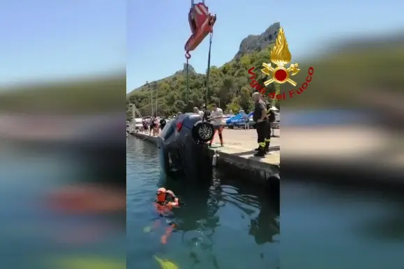 Il recupero della vettura finita in acqua a Cagliari (foto da frame video Vigili del Fuoco)